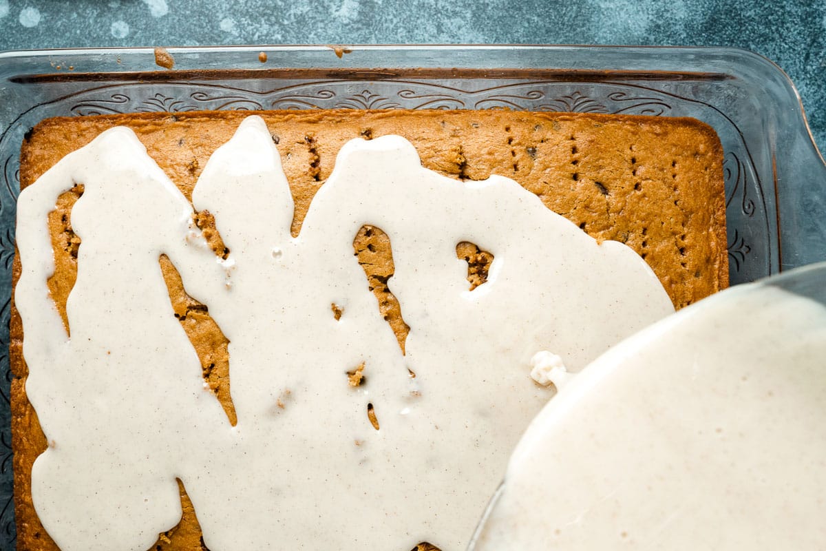 pouring spiced milk over pumpkin cake