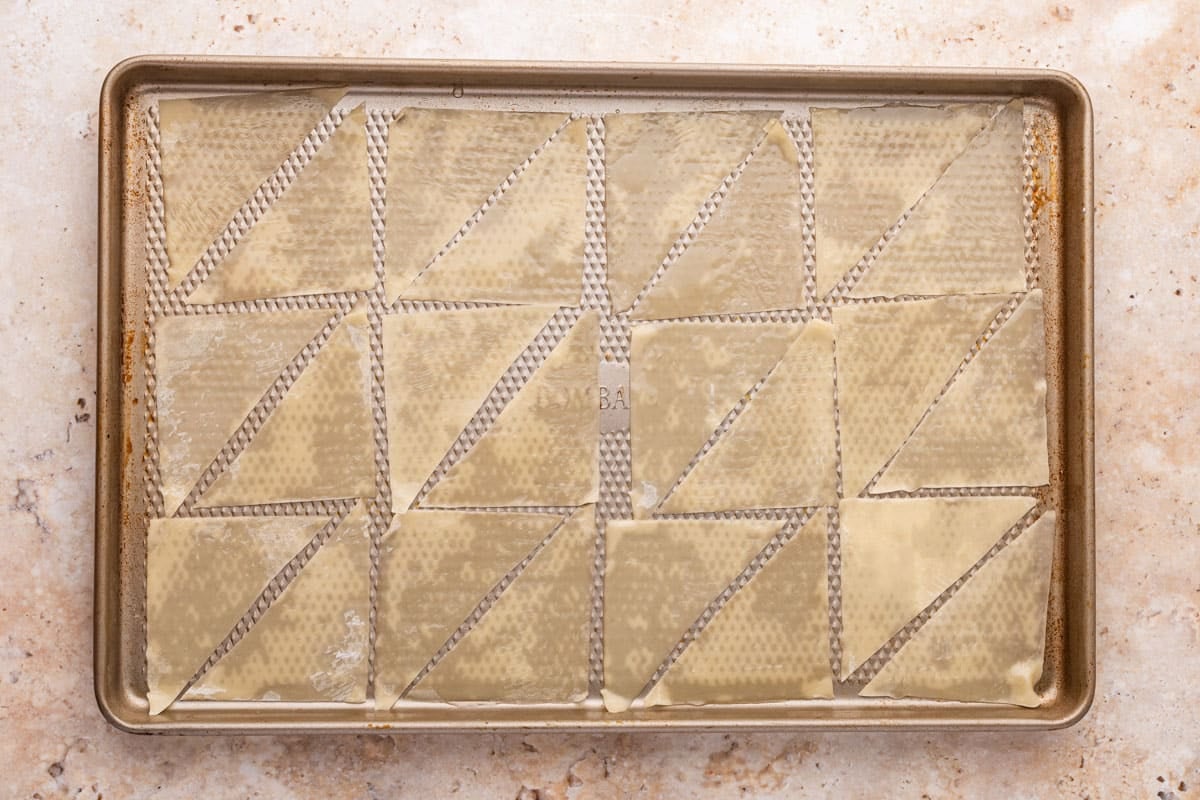 unbaked wonton chips on a baking sheet