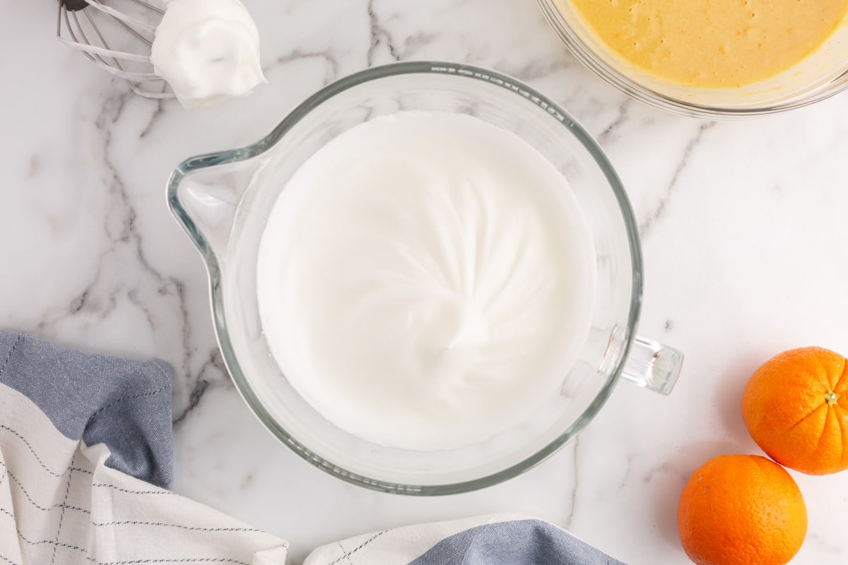 whipped egg whites in a glass bowl