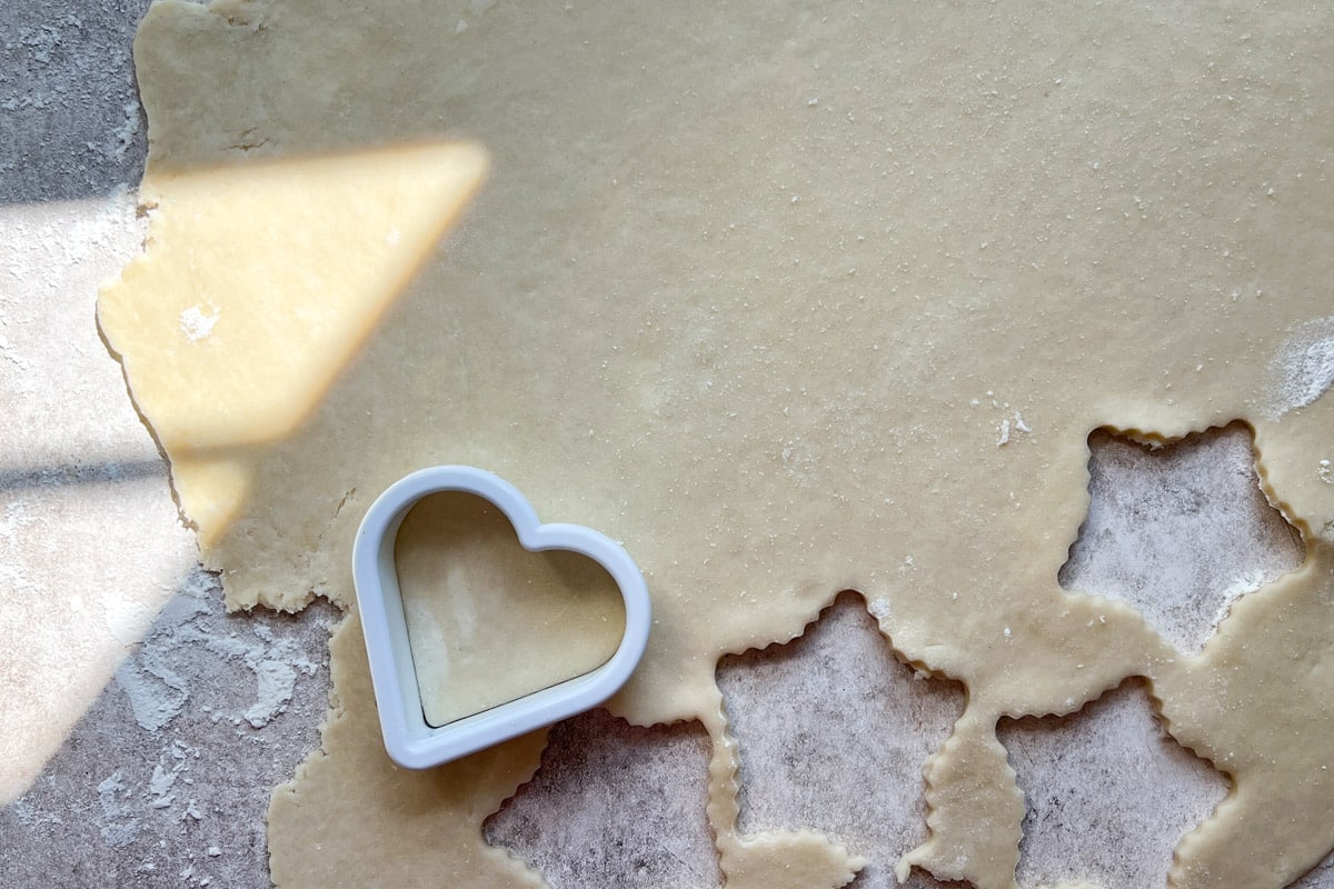 cutting out a heart shape from pie crust