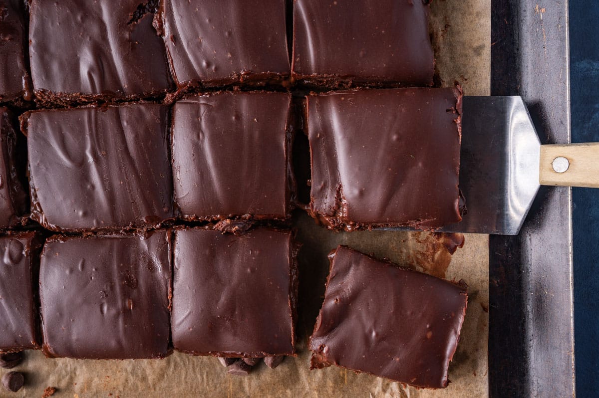 overhead view of sliced brownies with frosting