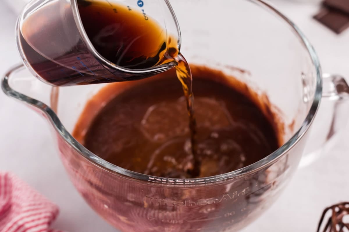 pouring coffee into cake batter