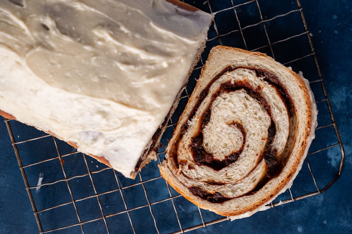 overhead view of sliced cinnamon raisin bread on a rack