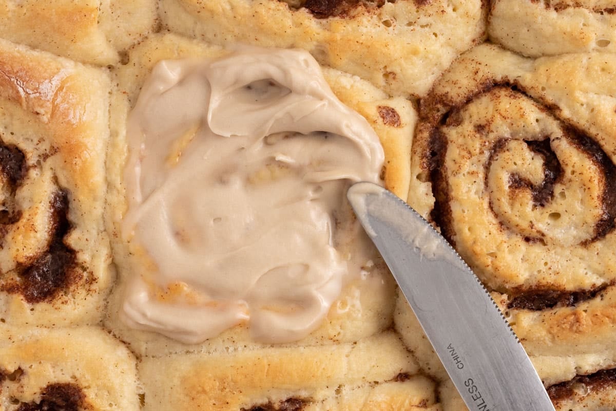 overhead view of cream cheese frosting for cinnamon rolls