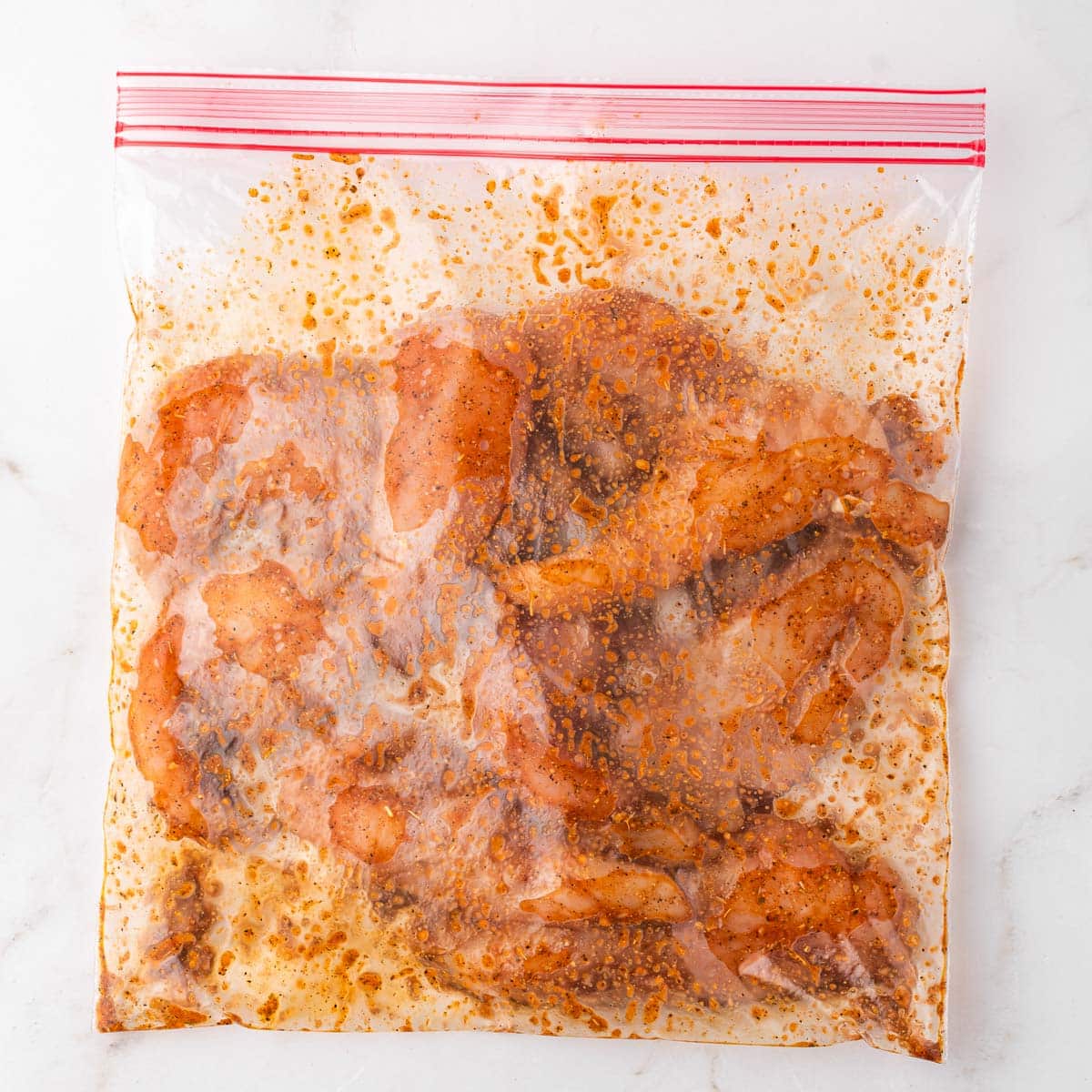 chicken marinating in a bag