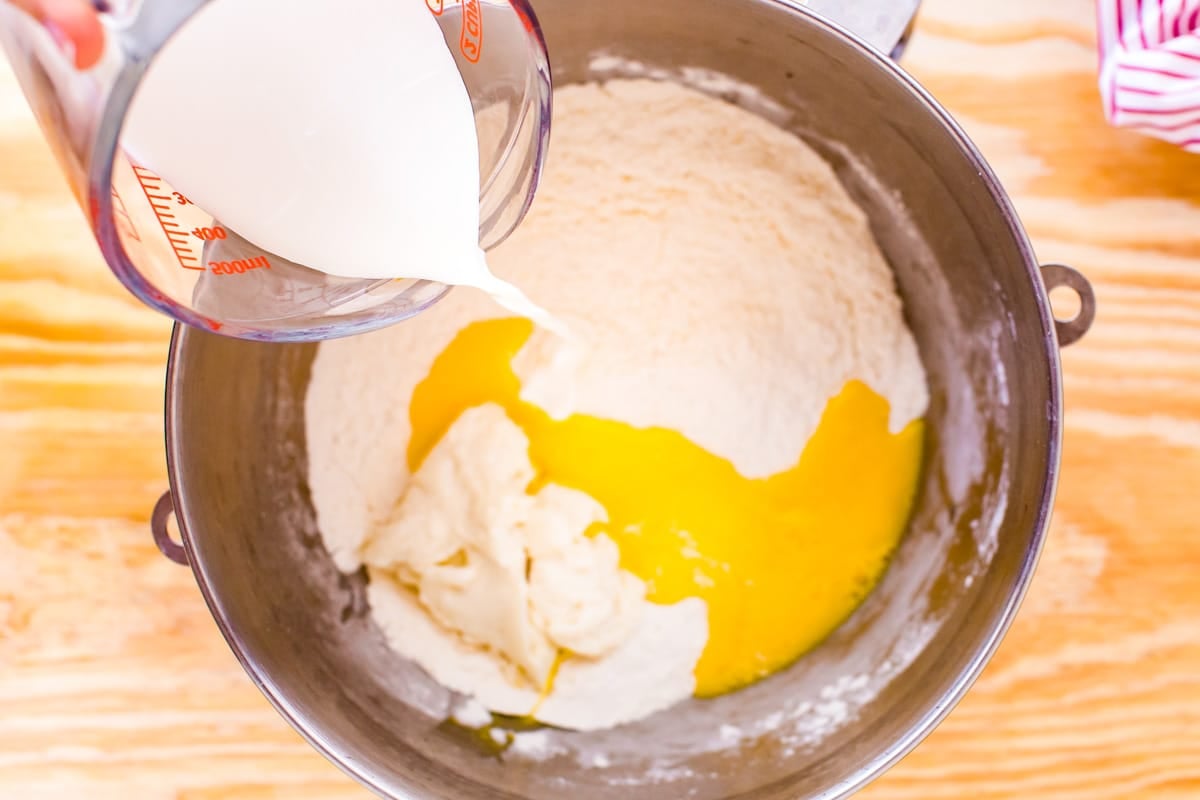 pouring milk into dough