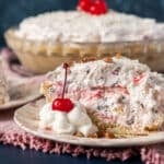 creamy fruit pie on a plate with a cherry