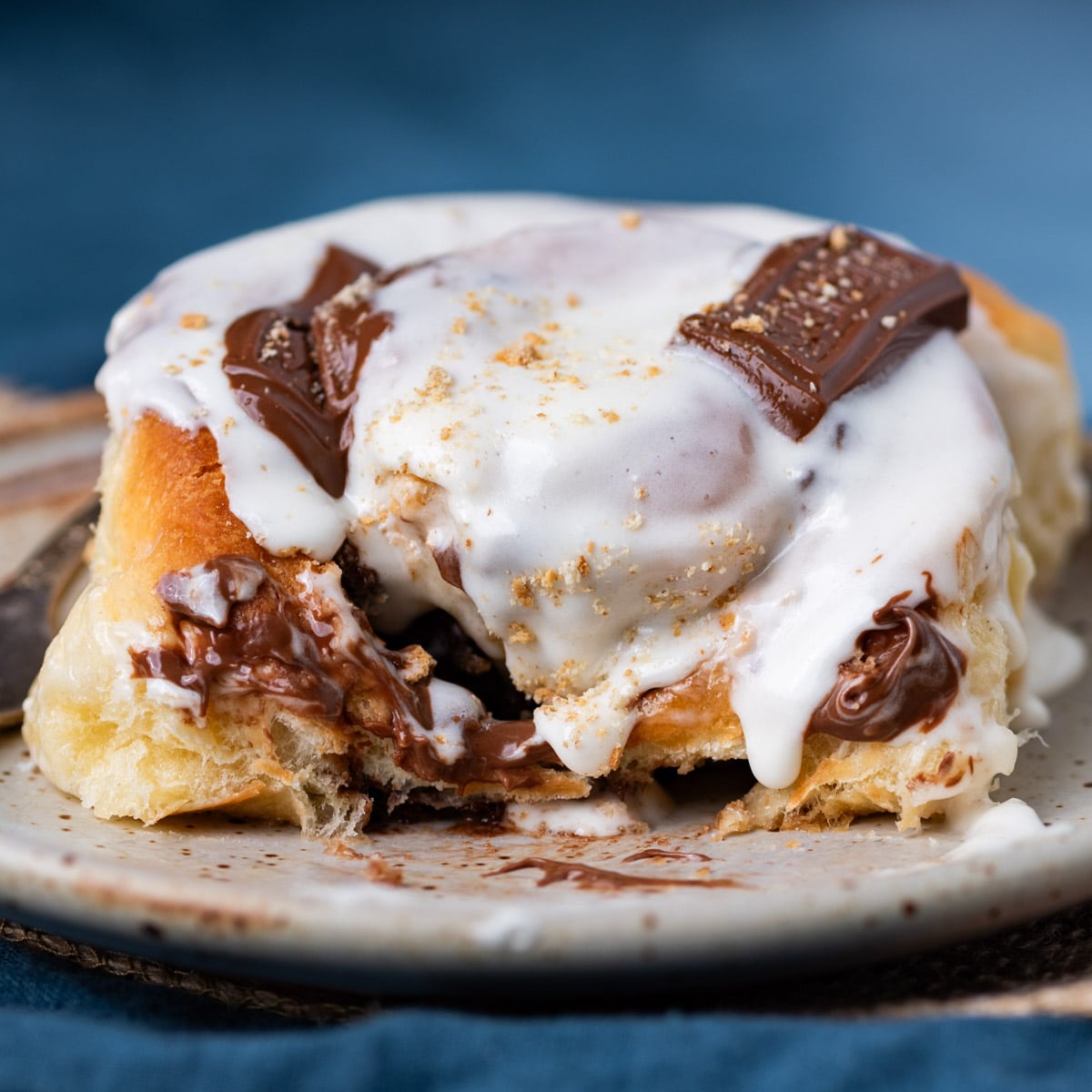 gooey s'more cinnamon roll with marshmallow frosting
