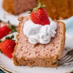 a piece of strawberry angel food cake on a plate with whipped cream