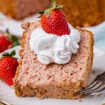 a piece of strawberry angel food cake on a plate with whipped cream