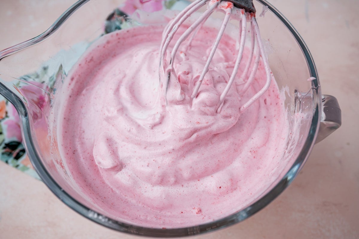 angel food cake batter in a bowl with a whisk