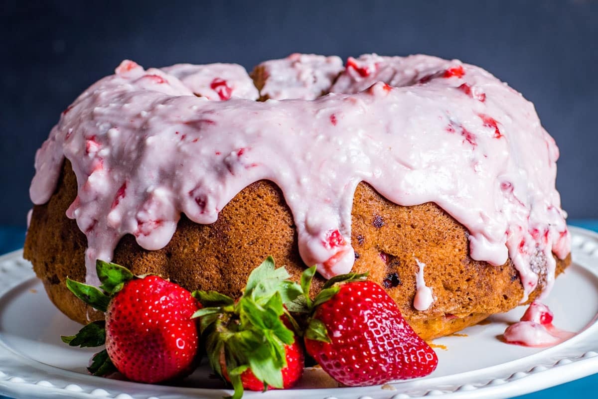 a glazed strawberry bundt cake on a table