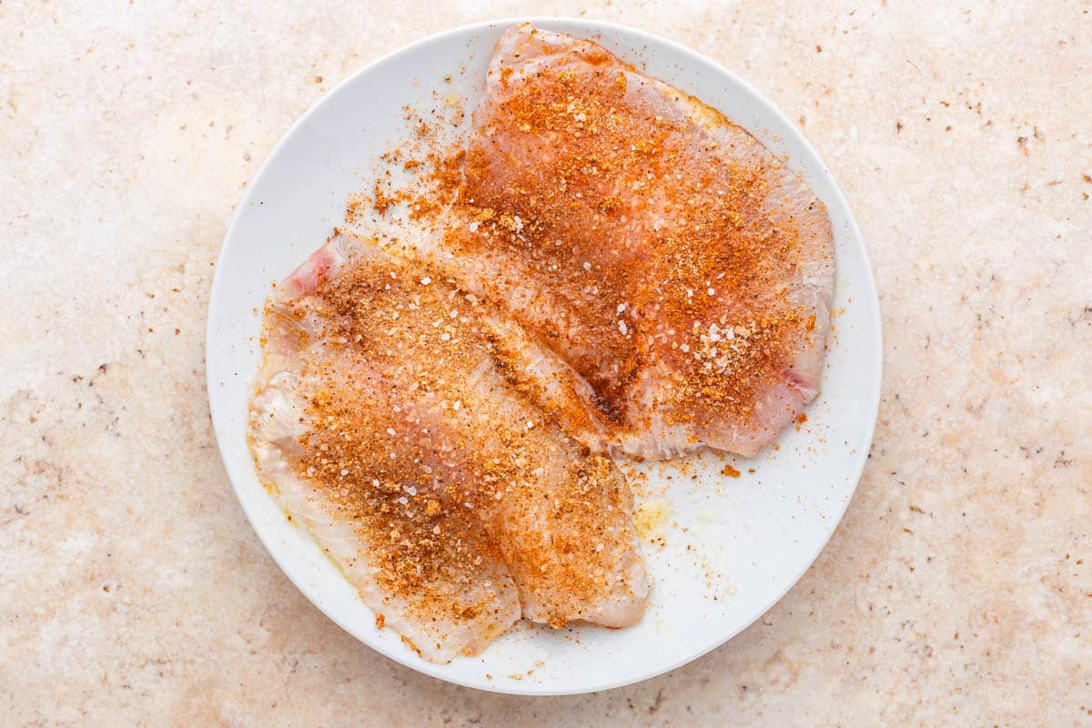 seasoned tilapia on a plate