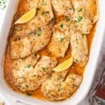 baked tilapia with lemon in a baking pan