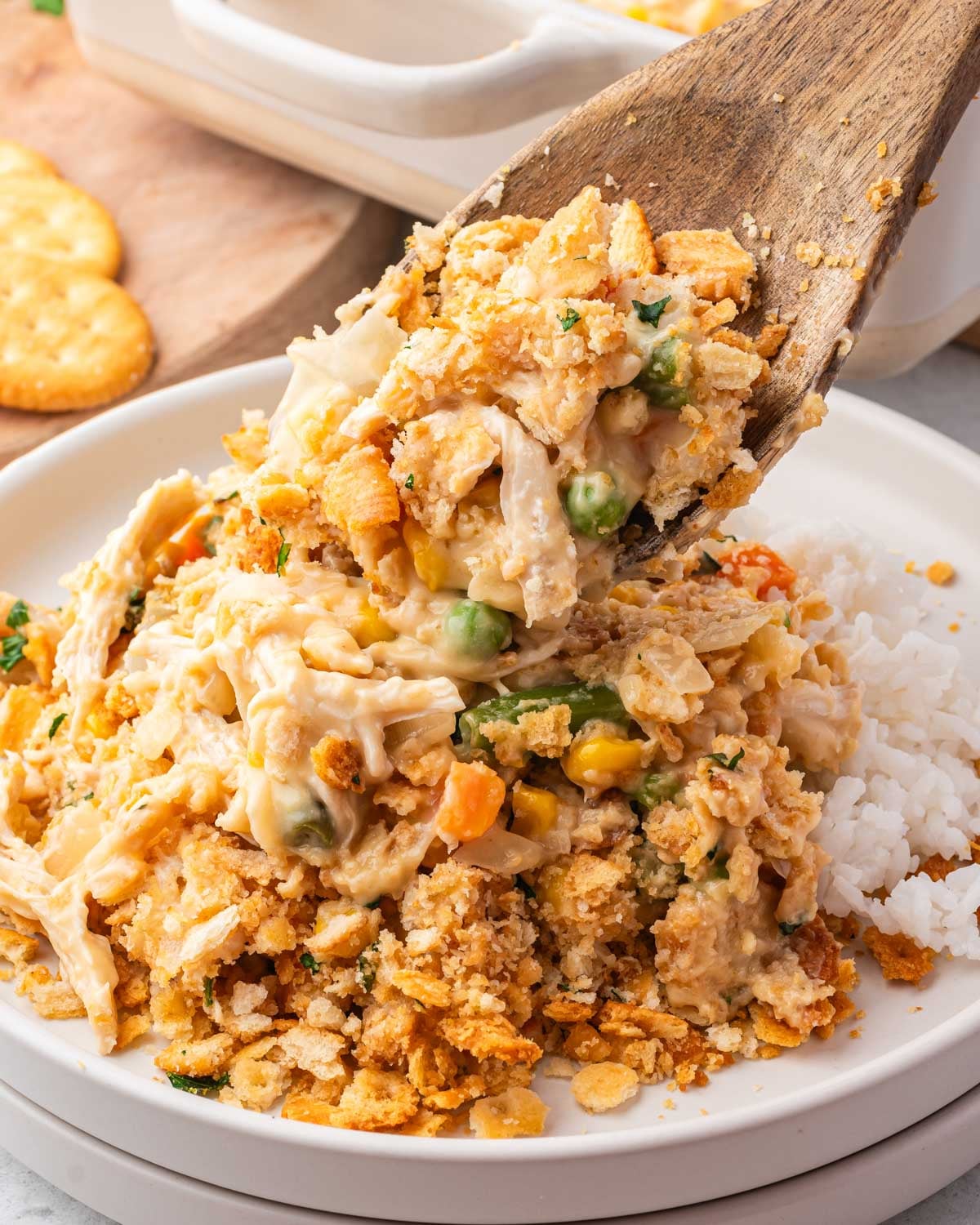 spooning chicken casserole onto a plate