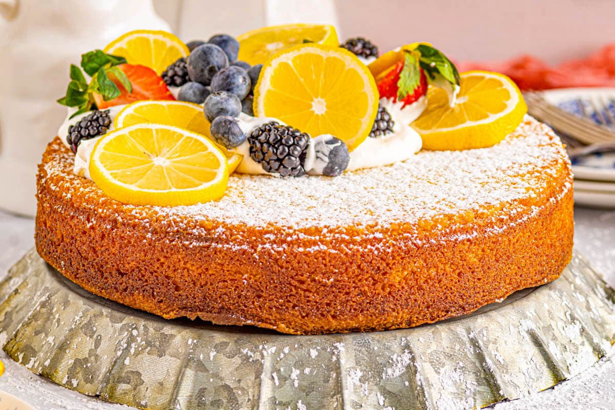 fresh fruit piled on top of a lemon olive oil cake