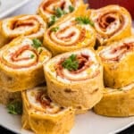 a plate of pepperoni rollups