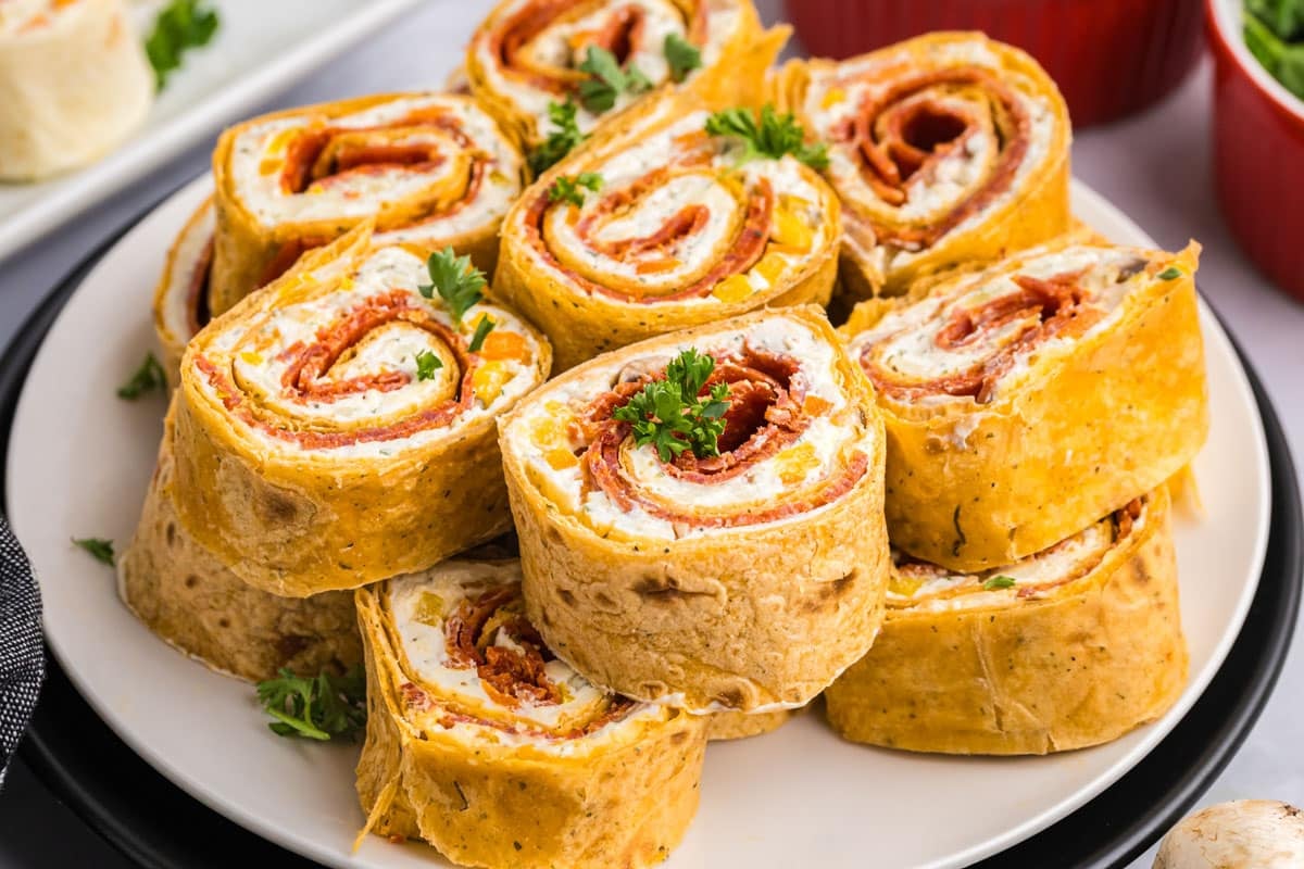 a plate of pepperoni rollups