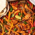 closeup of fajita peppers and chicken on a sheet pan