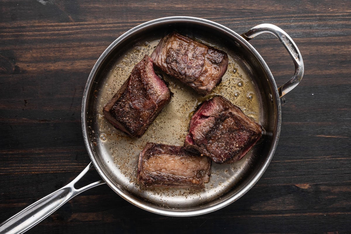 seared short ribs in a skillet