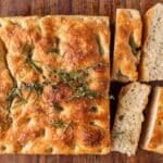 sourdough focaccia on a table cut into slices