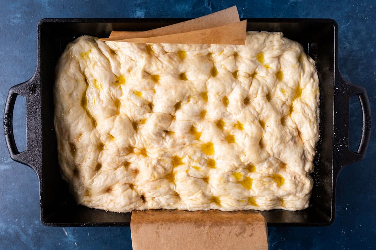 unbaked focaccia bread dough in a cast iron pan