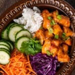 overhead view of a bowl with bang bang chicken and veggies