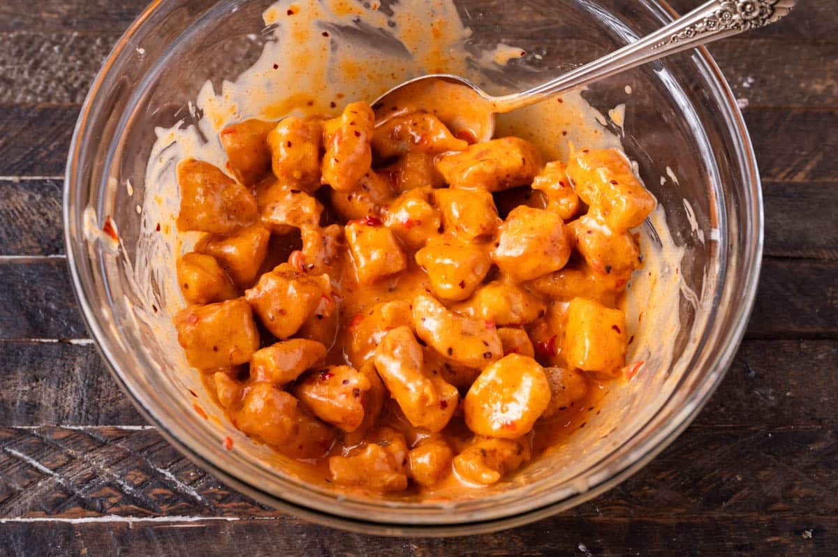 chicken tossed with bang bang sauce on a table