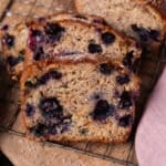 sliced blueberry banana bread on a wire rack