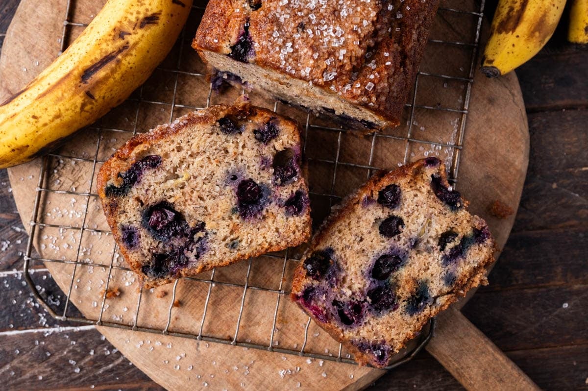 blueberry bread with bananas on a wire rack