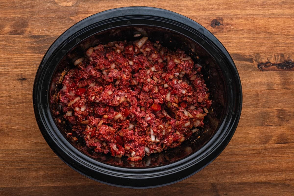 uncooked ground beef for tacos in a slow cooker