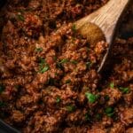 a spoon in a slow cooker with taco meat