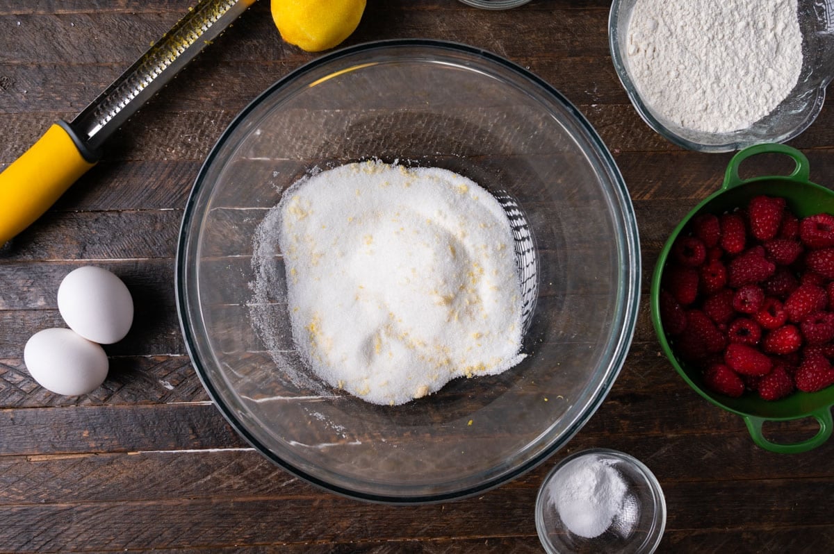 sugar in a bowl with lemon zest pressed in