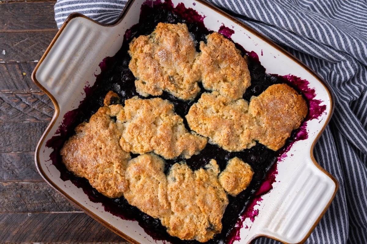 blueberry cobbler in a white baking dish