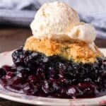 blueberry cobbler on a plate with ice cream