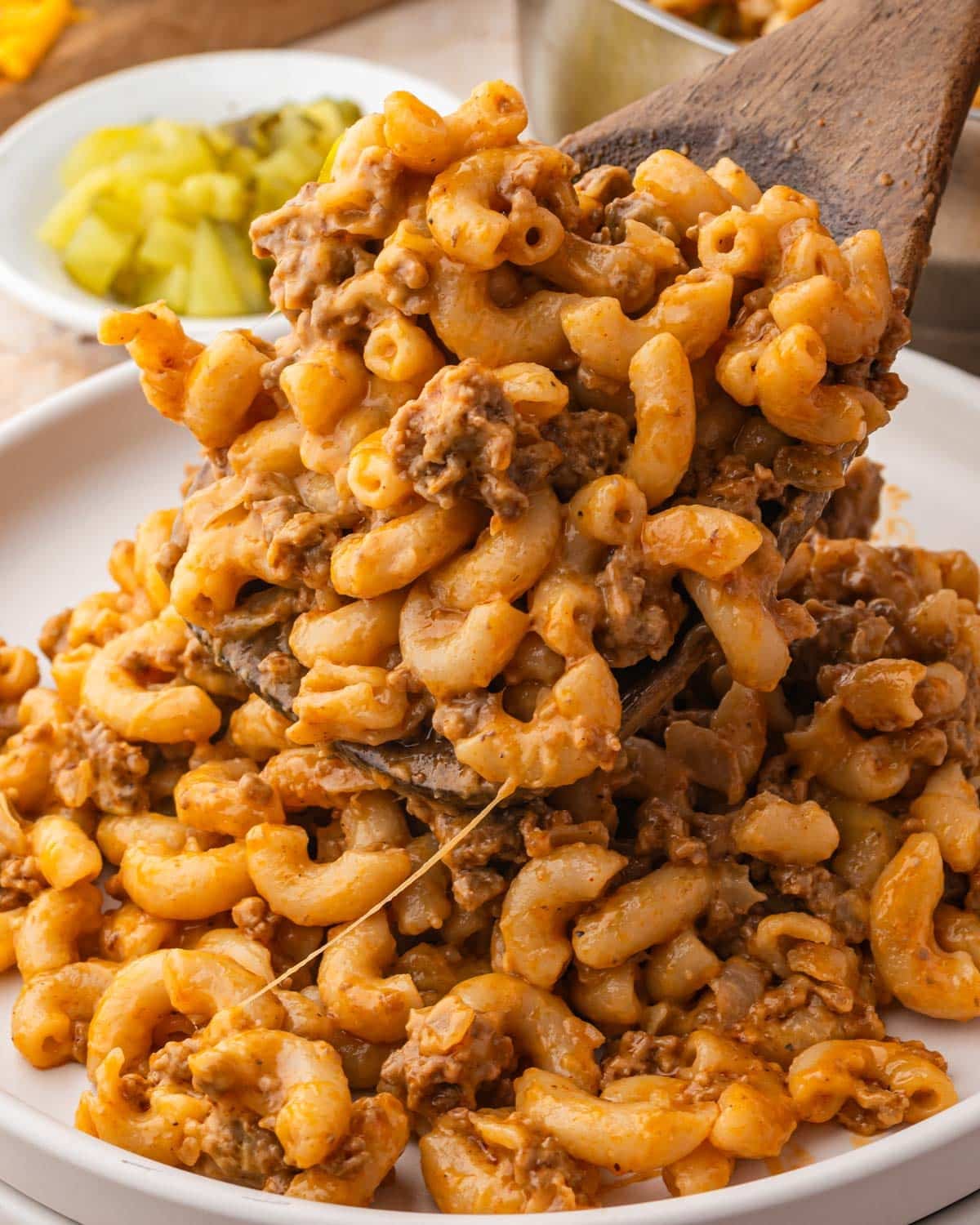 spooning cheeseburger mac onto a plate