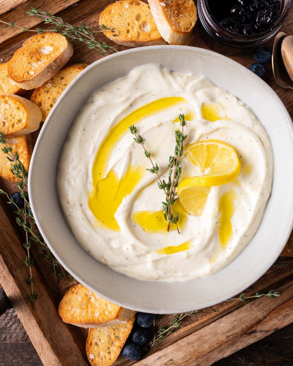 a bowl of whipped ricotta with lemon and olive oil