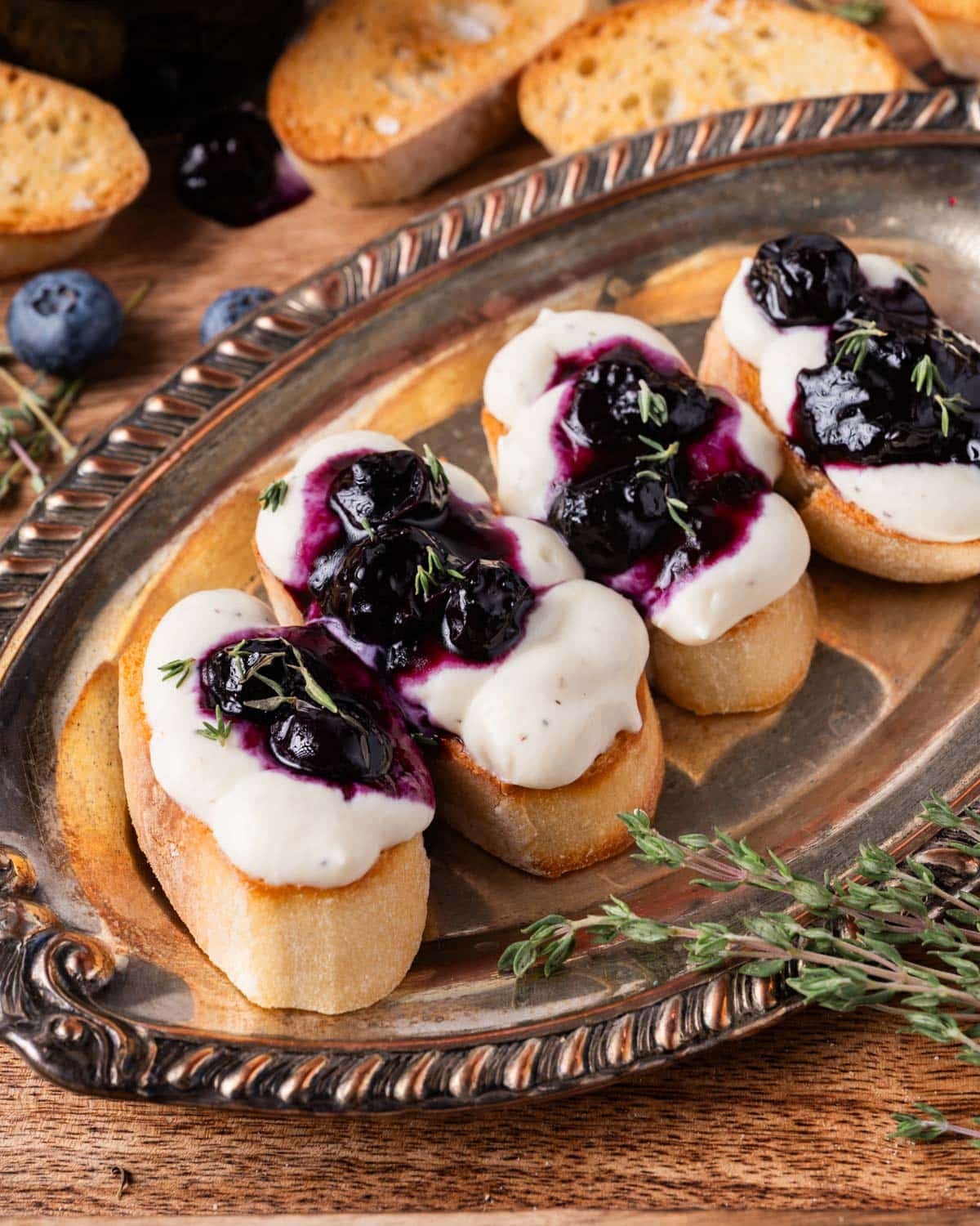 ricotta toast with blueberry thyme jam on a silver plate