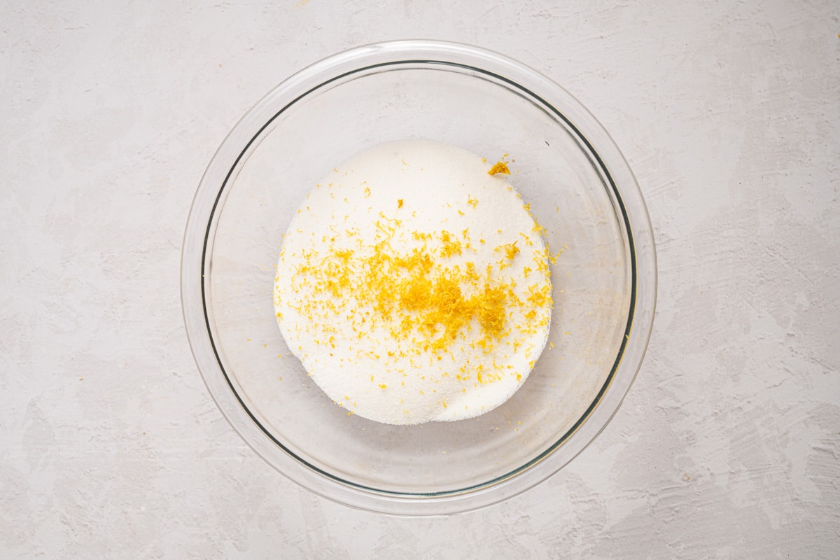 lemon zest over sugar in a bowl