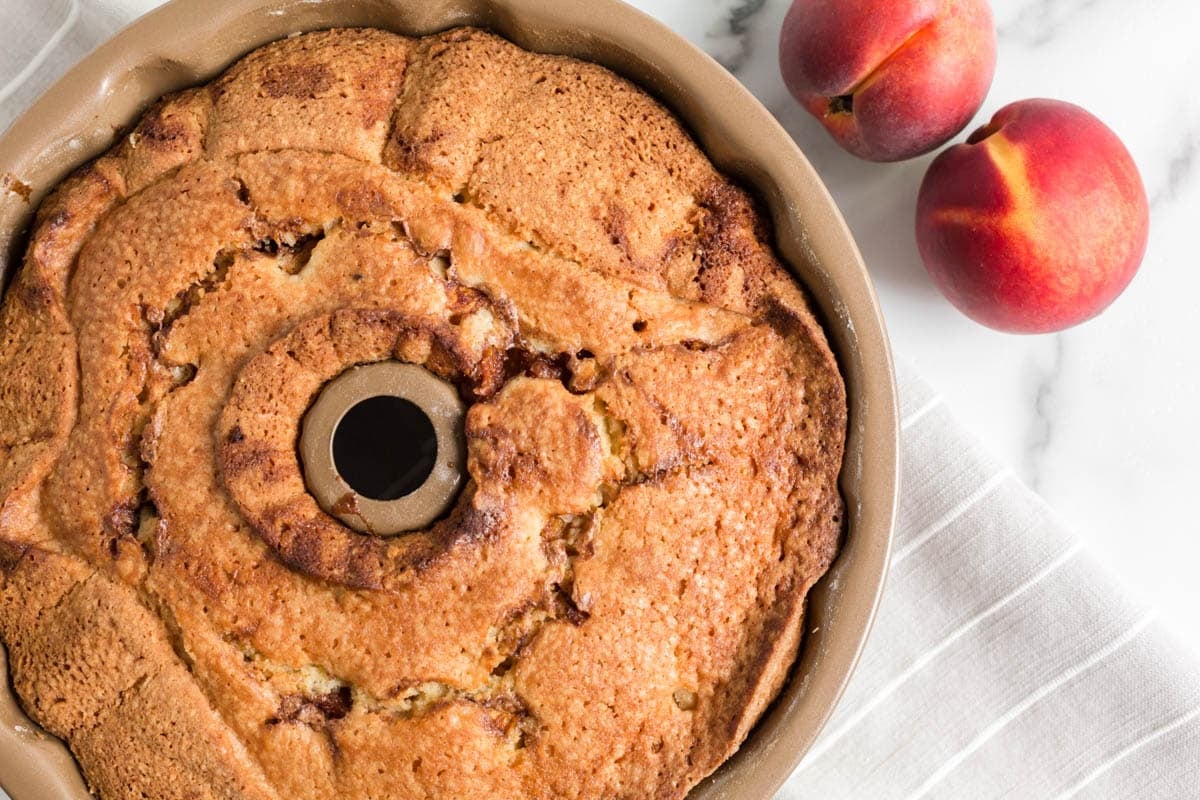 baked cinnamon peach bundt cake in a pan