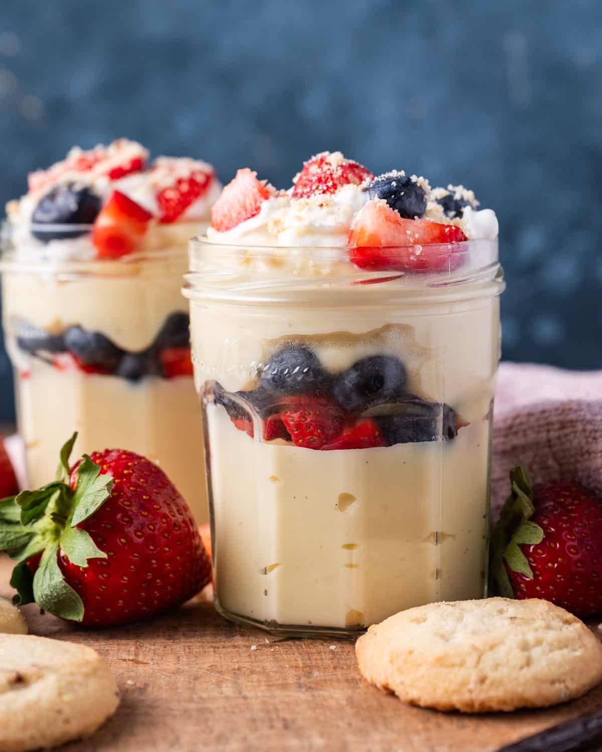 a glass jar with pudding and fresh fruit in it