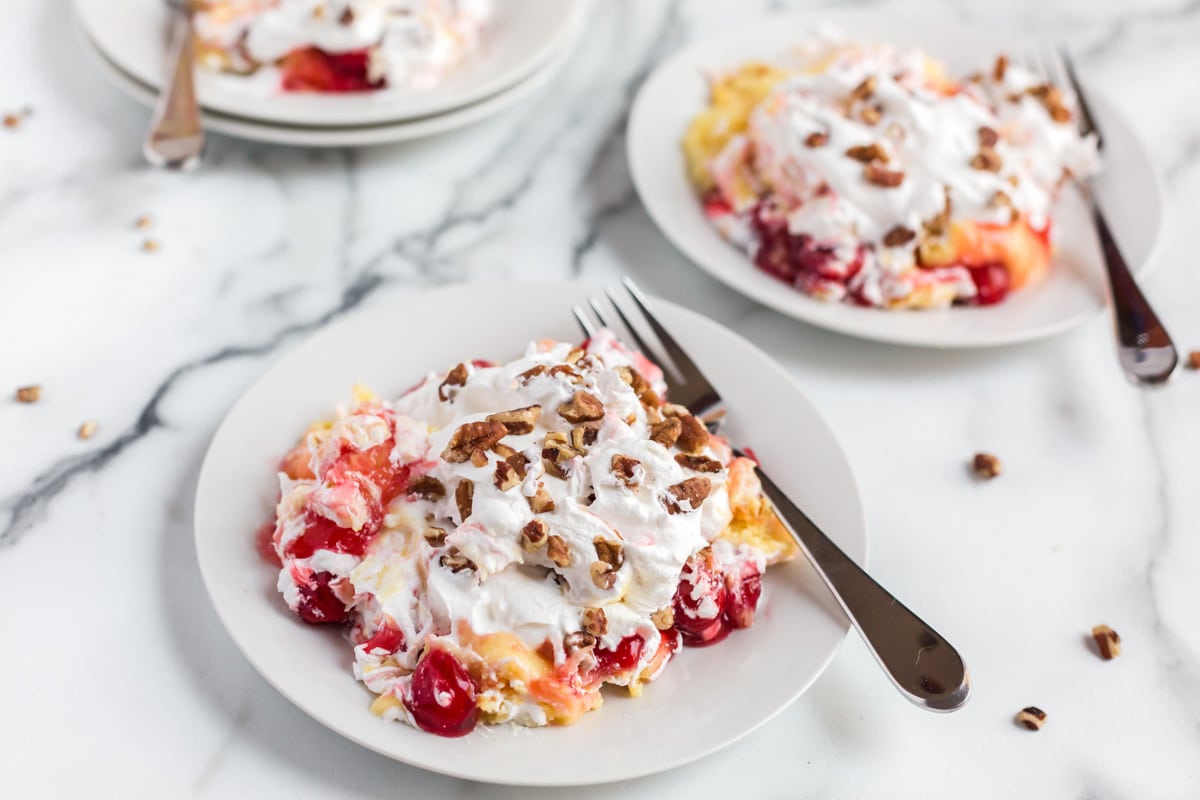 fluffy layered cake, pudding and cherry pie filling on a plate