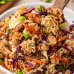 ramen noodle salad on a large wooden spoon