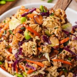 ramen noodle salad on a large wooden spoon