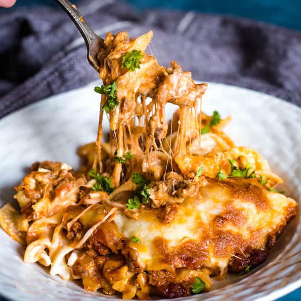 a fork pulling up cheesy casserole